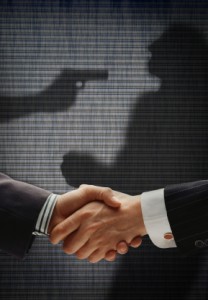image of two people shaking hands with a shadow image showing one person holding a gun