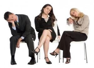 Image of three business professionals dozing in their chairs