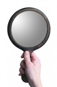 image of a hand holding a mirror