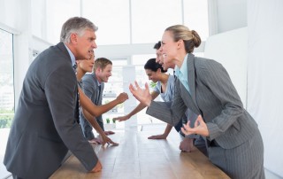 Business professionals arguing in a meeting