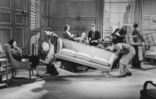 Image of movers carrying out furniture from an office
