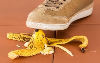 Person walking, about to slip on a banana peel