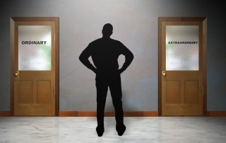 Image of man staring at two closed doors: one with word extraordinary and the other with ordinary
