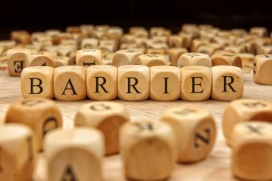 wooden tiles spelling the word barrier