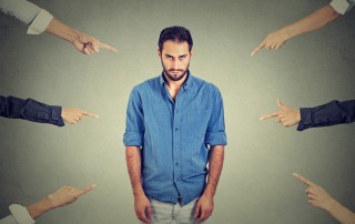 Upset man with fingers pointing at him