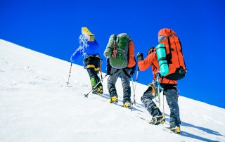 Image of three mountain climbers on mountain