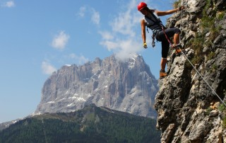 Mountain climber leading her team looks back to offer guidance and help.