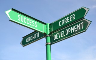Street signs with words: Success, Career Development, Growth