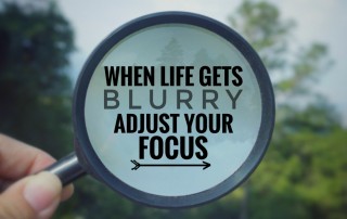 Magnifying glass with words reading: When life gets blurry, adjust your focus