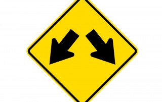 Road sign with diverging arrows