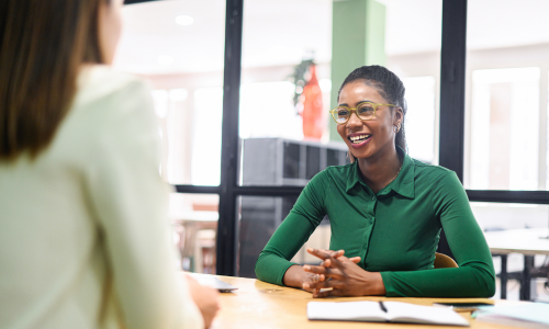 Image of person striving to push a large rock and straining
